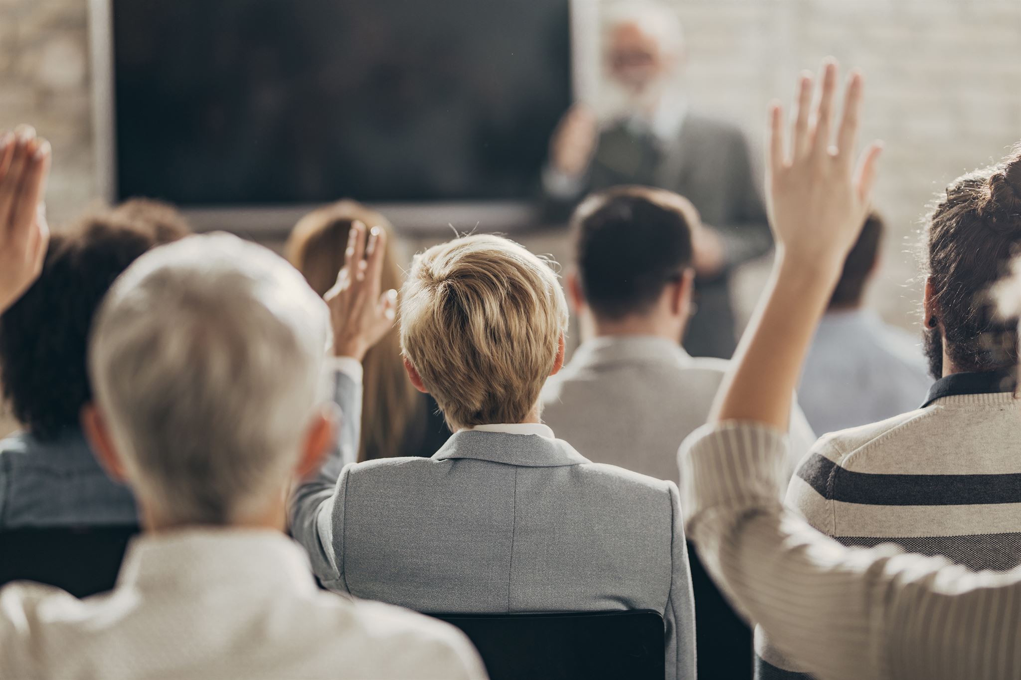 Students-raising-hands-during-a-lecture